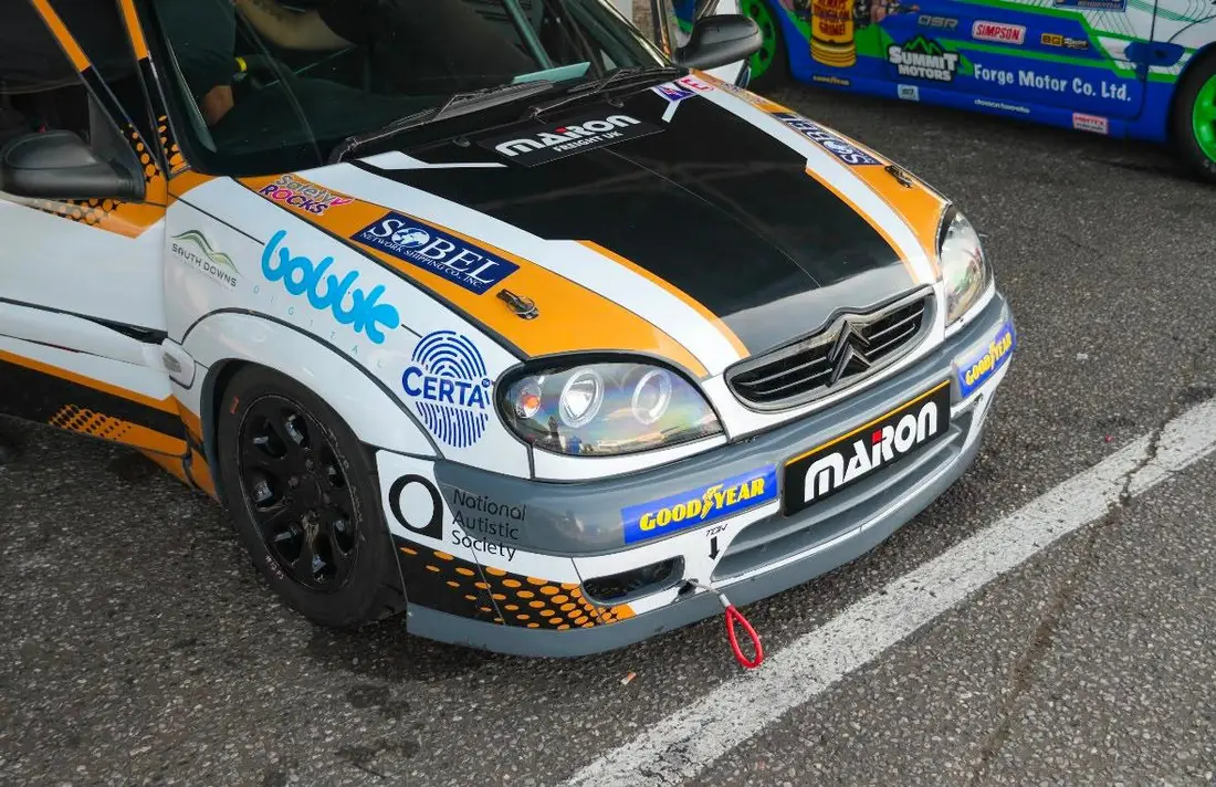 Close view of the front of the number 12 Citroën Saxo, showing the Certa MPS logo and fingerprint mark on the front wing.