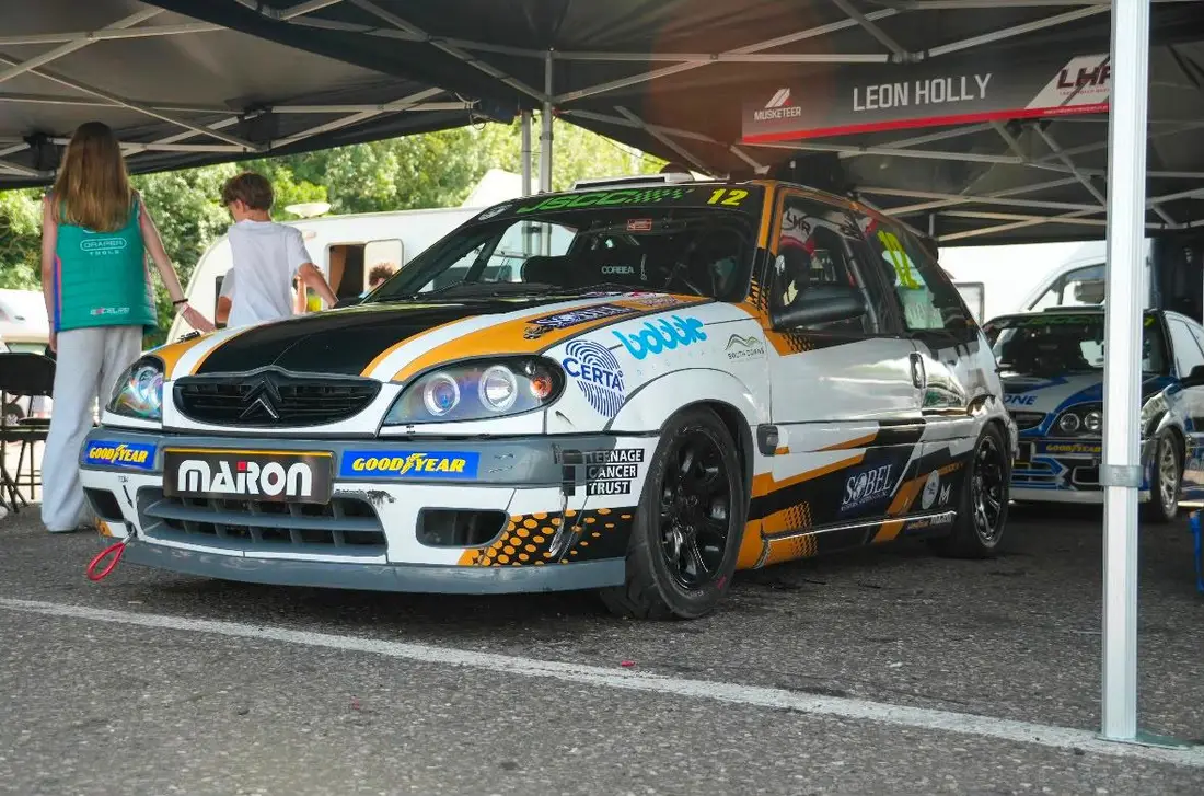 The number 12 Citroën Saxo in the paddock under an awning, with the Certa MPS logo on the front wing alongside Goodyear and Marion branding.