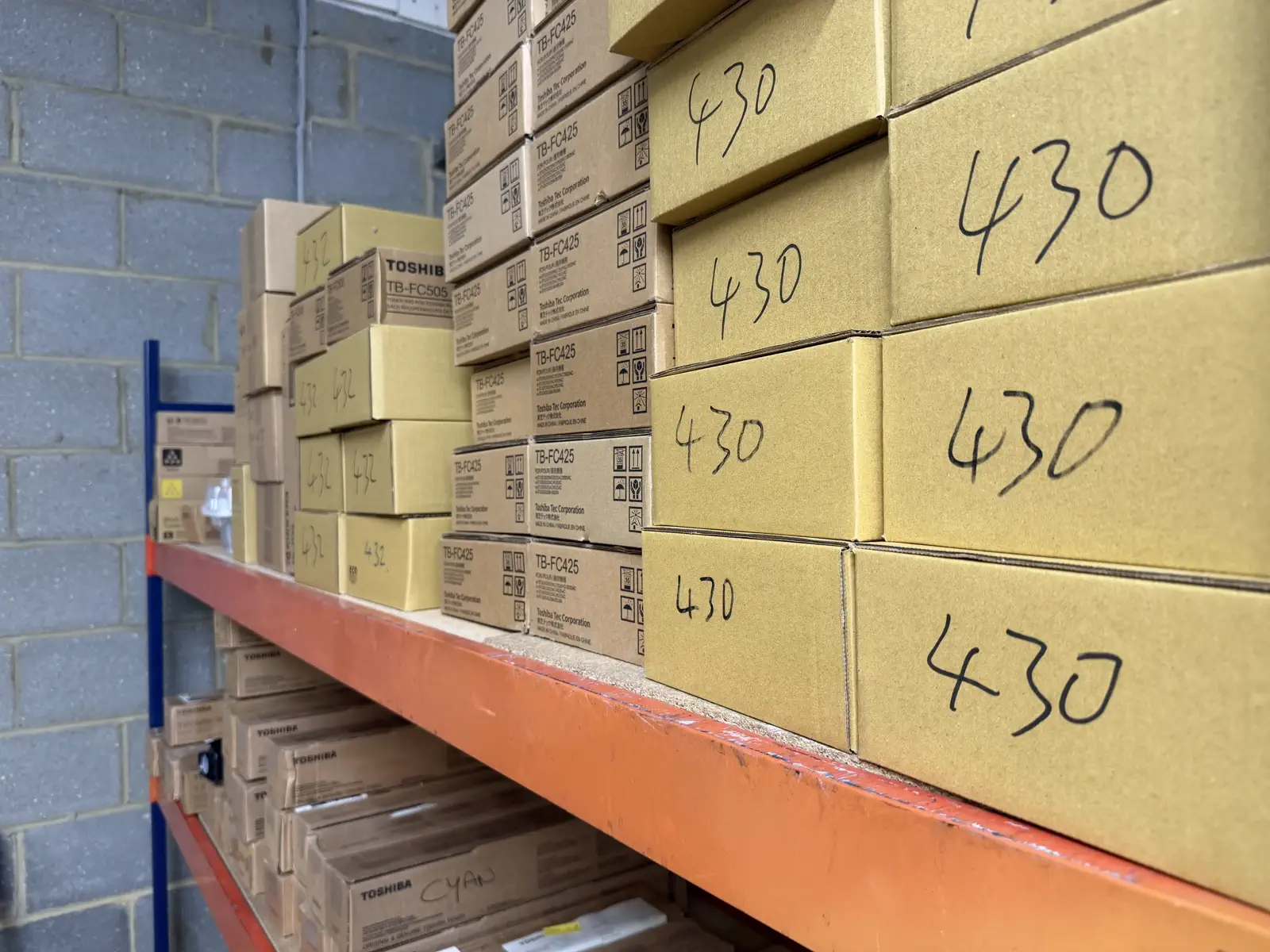 Boxed toner stacked and labelled by cartridge code