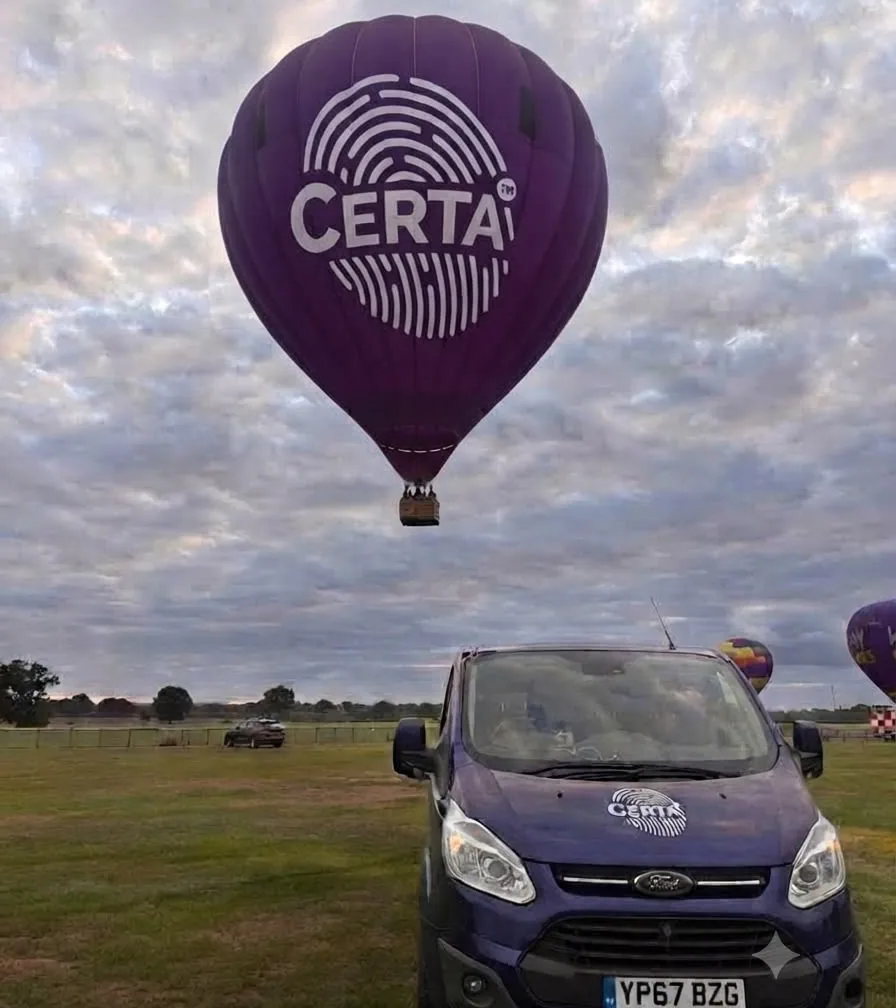 Certa branded hot air balloon lifting off above a Certa MPS van