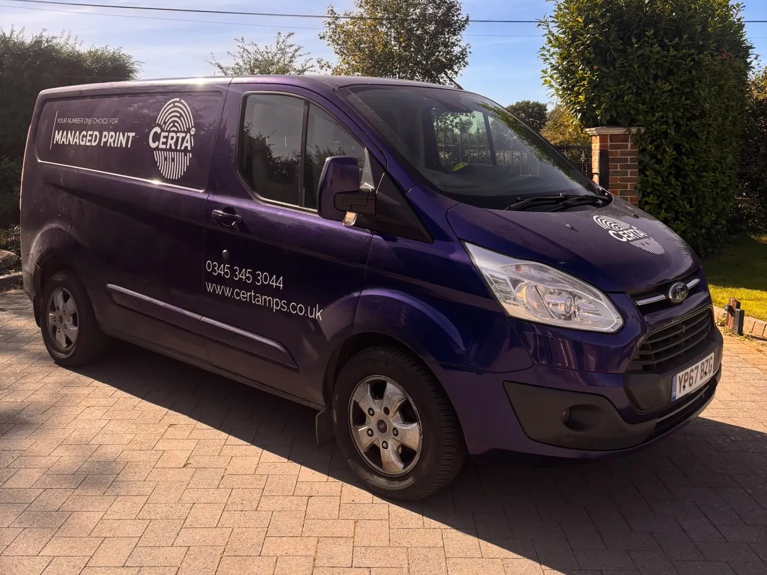 Purple Certa MPS van in managed print livery, parked on a driveway